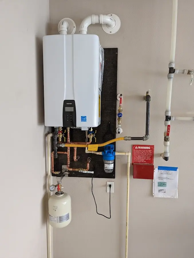 Professional plumber installing copper piping in a Elizabeth home